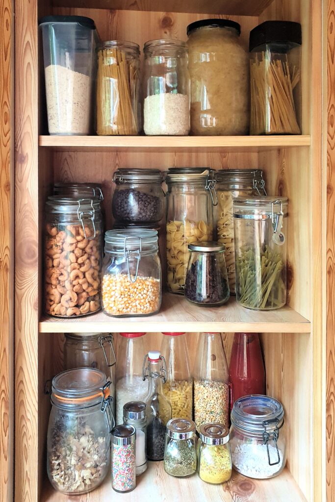 reusable glass jars on pantry shelf in kitchen